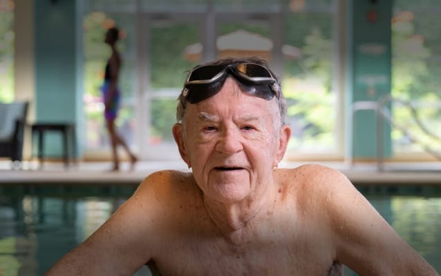 Senior man enjoying a swim in an indoor pool