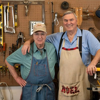 Two male residents smiling in a workshop