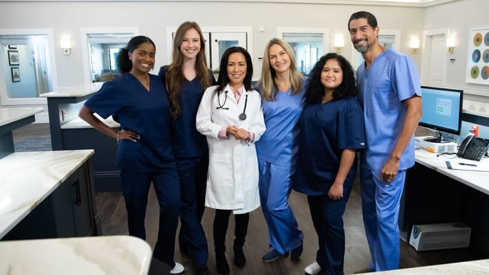 Staff members smiling in a facility common area