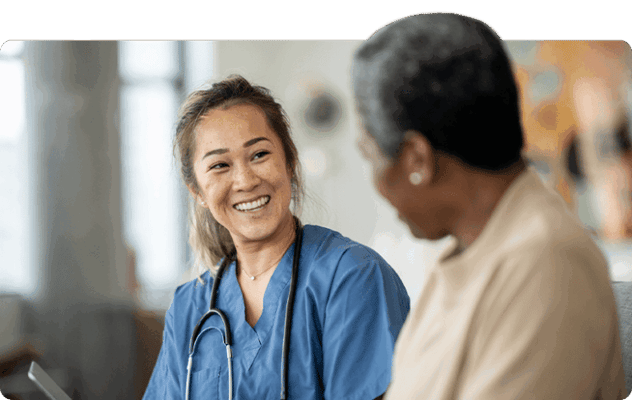 Caregiver smiling while interacting with a resident