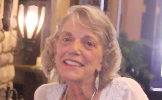 Resident smiling in a cozy interior setting