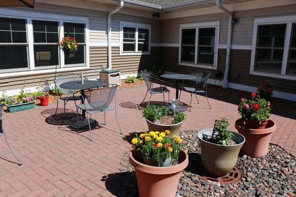 Outdoor seating area with flowers in a courtyard