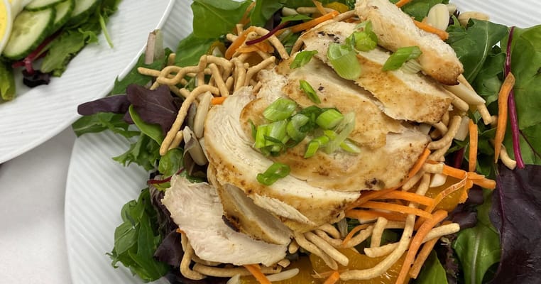 A delicious chicken salad with mixed greens and toppings