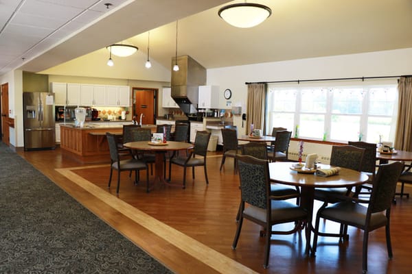 Bright dining room with multiple tables and chairs