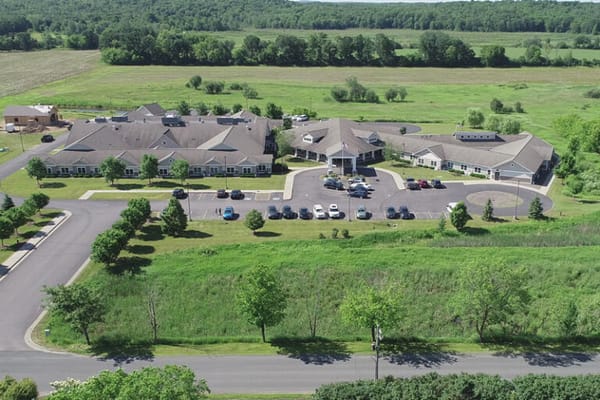 Aerial view of a senior living facility with green spaces