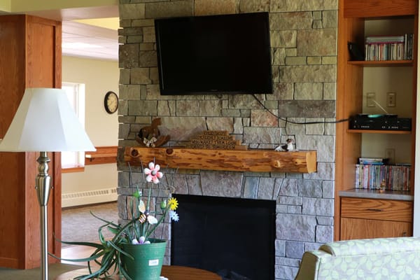 Cozy common area with stone fireplace and TV