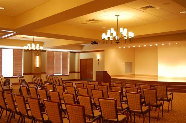 An interior activity room with chairs and stage