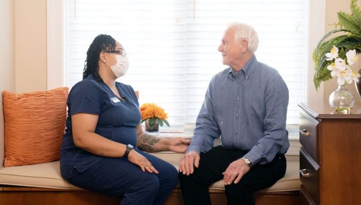 A caregiver and a resident sharing a moment indoors