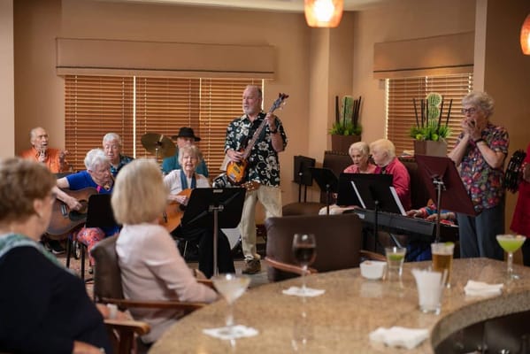 Residents enjoying a musical performance in a common area