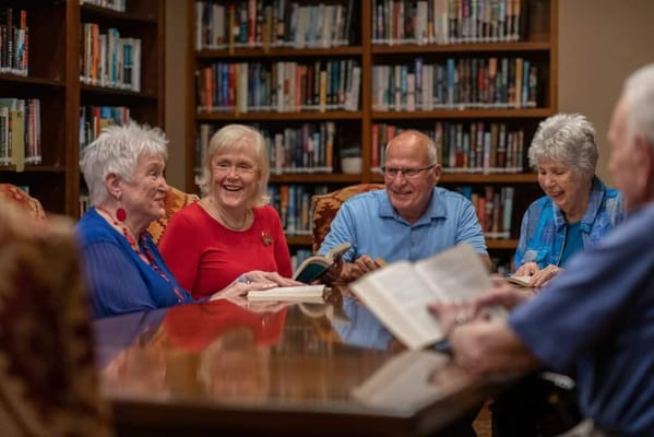 Residents enjoying a lively book discussion in a library