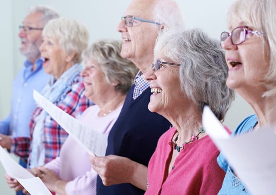 Seniors participating in a singing activity