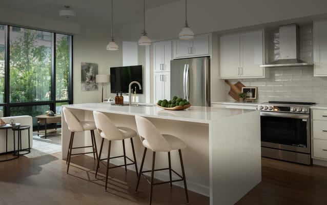 Modern kitchen with bar seating and large windows