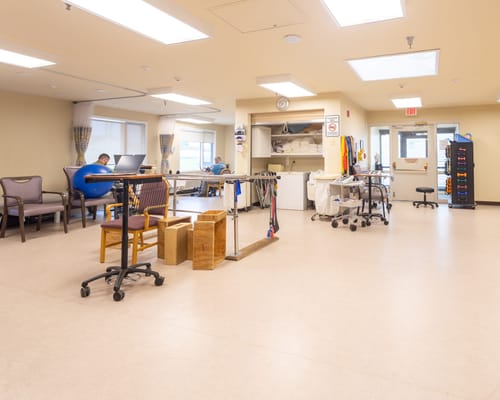Interior view of a therapy room with equipment and seating