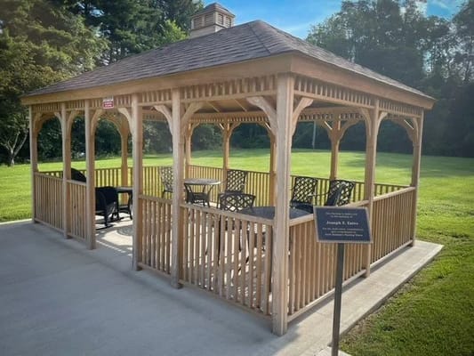 Wooden gazebo in a green outdoor space