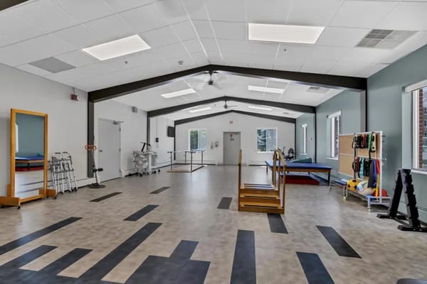 Bright and spacious physical therapy room with equipment