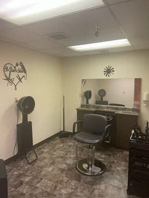 Bright hair salon area with styling chair and mirror