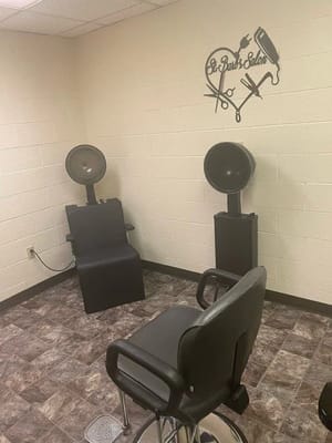 Hair salon setup with chairs and hairdryers