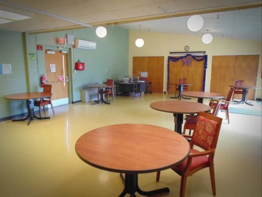 Interior common area with empty tables and chairs