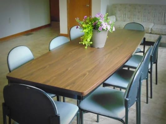 Dining table with chairs and a flower vase