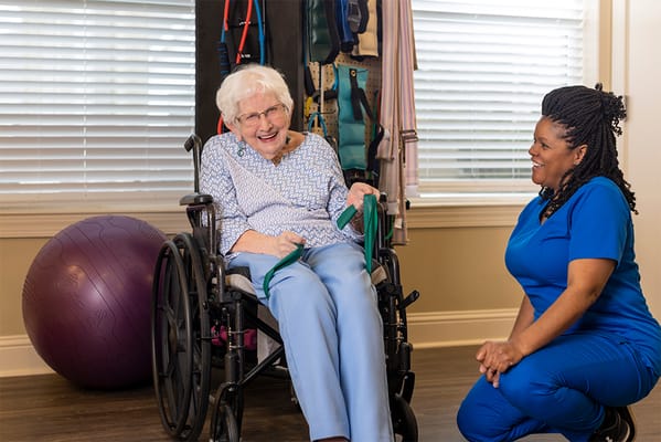 Resident engaging in an activity with a staff member