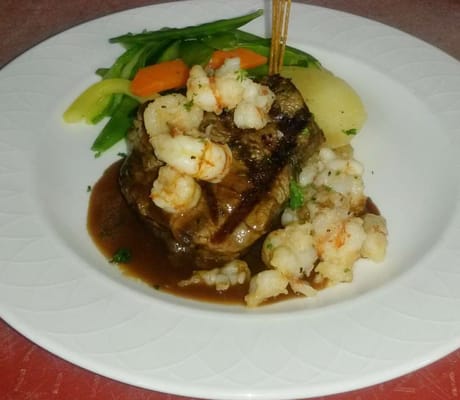 Plate of surf and turf with vegetables and sauce