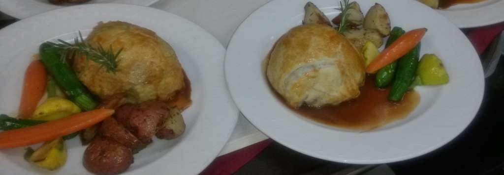 Two plates of gourmet food with vegetables