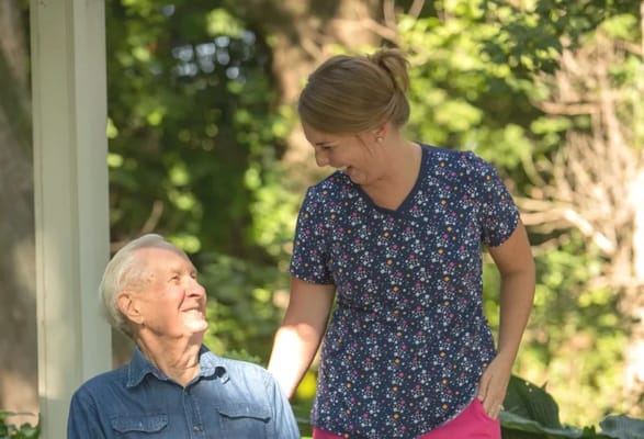 A caregiver and a resident enjoying time outdoors
