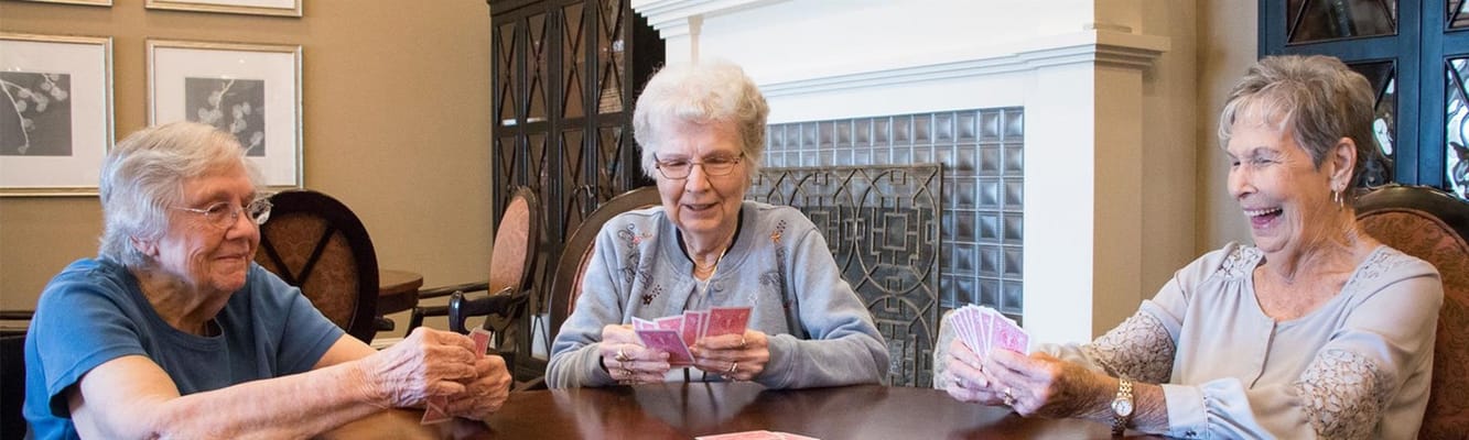 Residents playing cards in a cozy social area