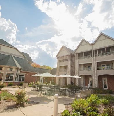 Exterior view of a senior living facility with gardens