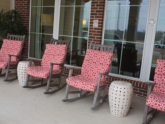 Rocking chairs on a patio outside the facility