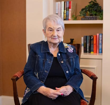 A senior woman sitting in a cozy living area