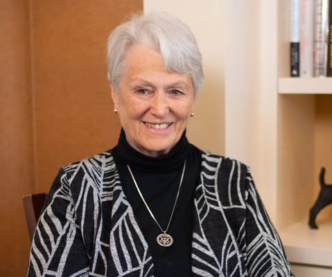 A smiling resident in a cozy common area