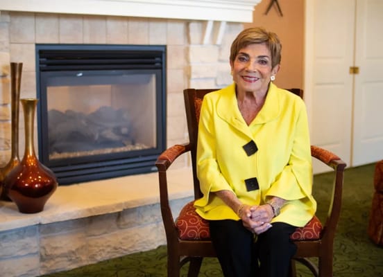 A resident sitting in a cozy lounge area