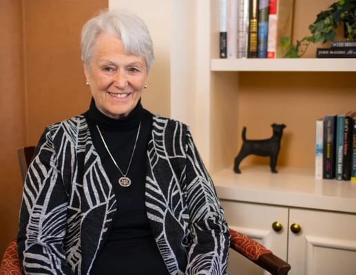 A smiling resident seated in a cozy common area