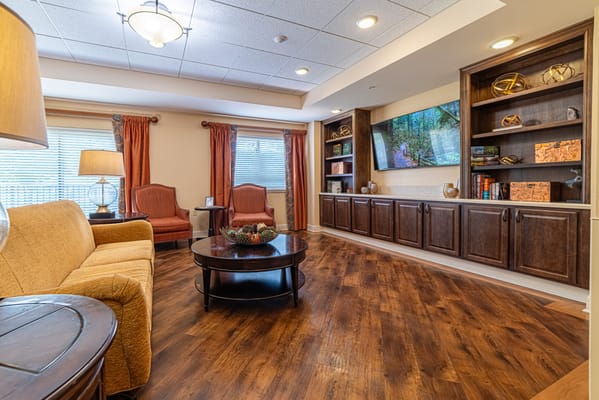 Cozy common area with seating and wooden shelves