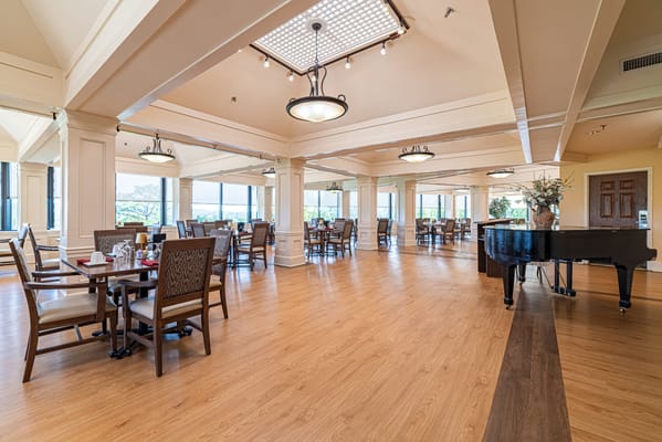 Bright dining room with tables and a piano