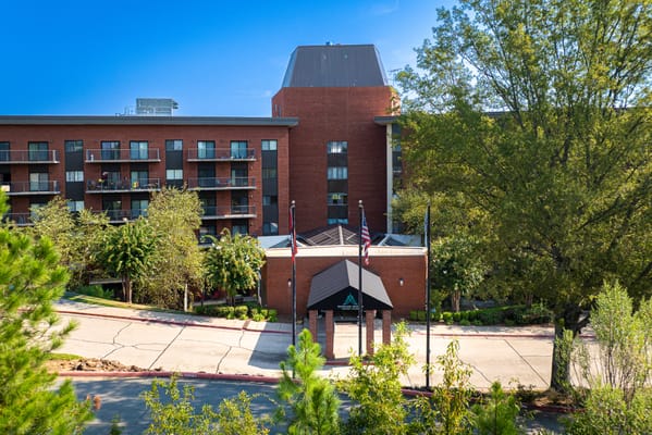 Exterior view of a senior living facility with trees