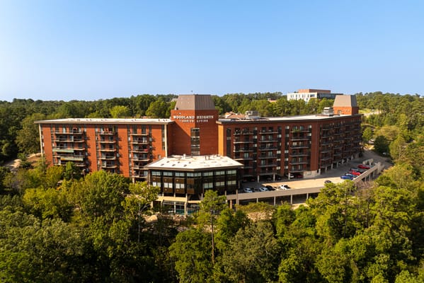 Aerial view of a senior living facility surrounded by trees