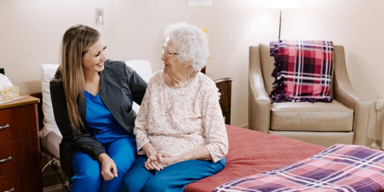Caregiver interacting with a resident in a cozy room