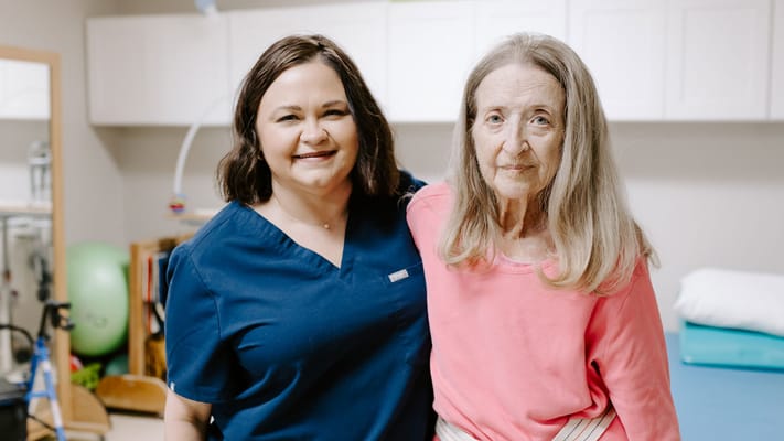 Care staff member smiling with a resident