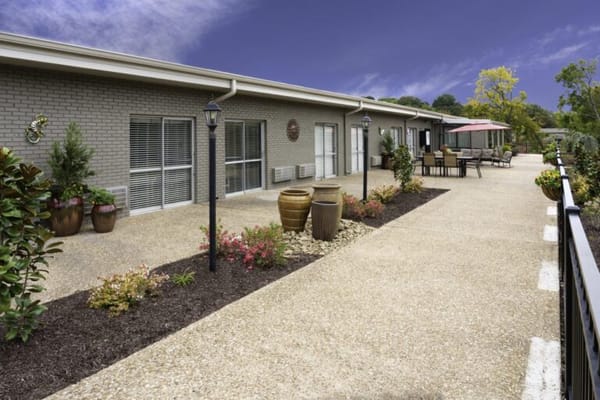 Outdoor pathway with seating and flower beds