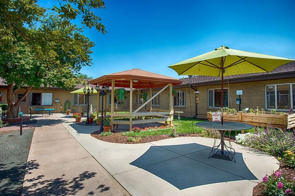 Outdoor garden area with seating and shade