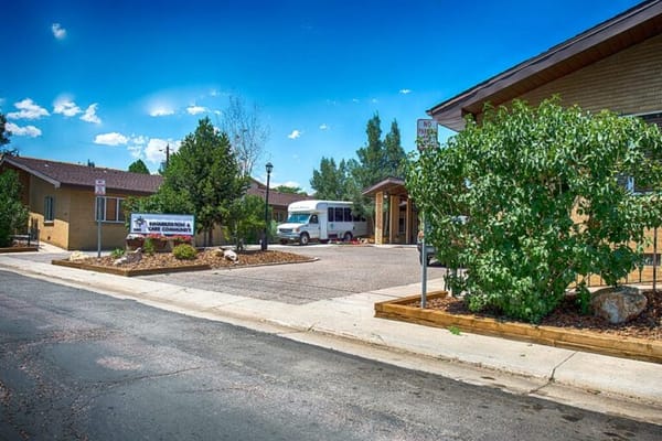 Exterior view of a senior living facility with transport van