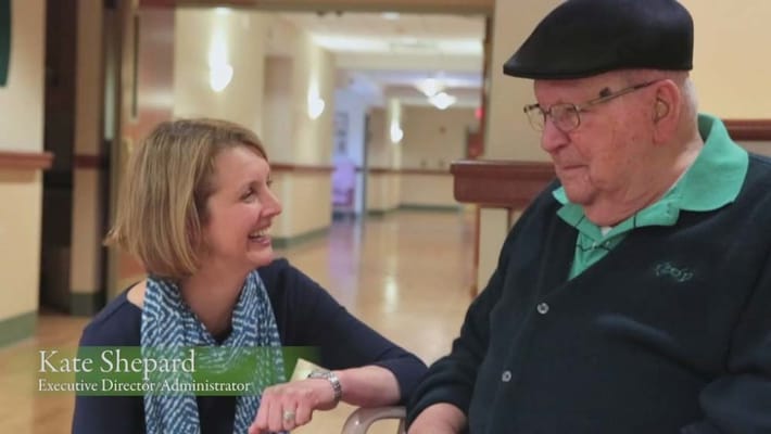 Director chatting with resident in a hallway