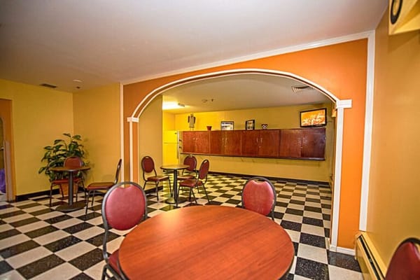 Common area in a senior living facility with tables and chairs