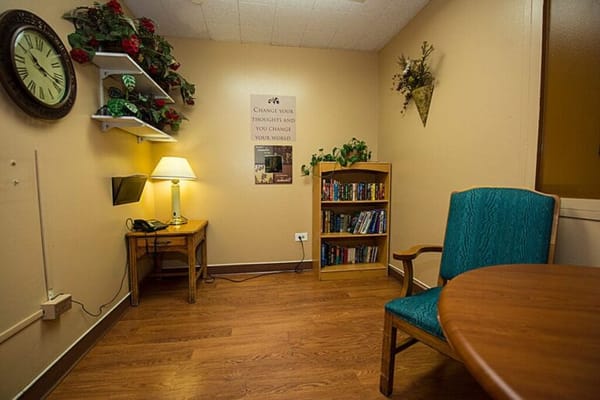 Cozy corner reading nook with bookshelves and a lamp