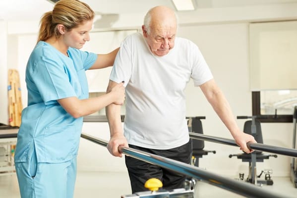 Physical therapy session with a staff member assisting a resident