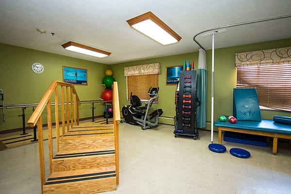 Interior view of a rehabilitation room with exercise equipment