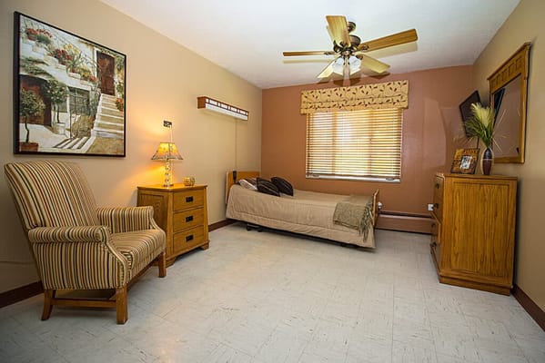 Cozy resident room with a bed and chair