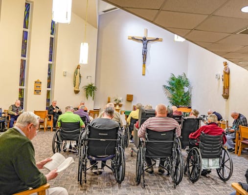 Group of residents in wheelchairs attending a chapel service